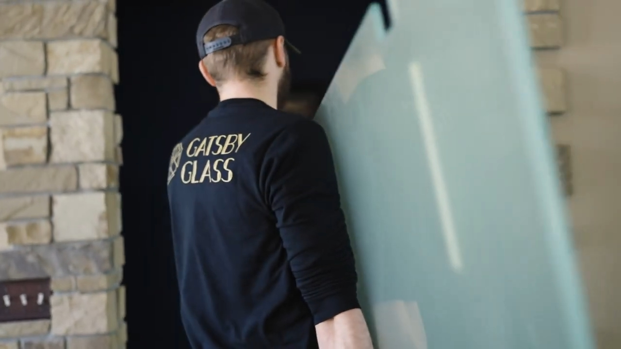 Man carrying glass panel